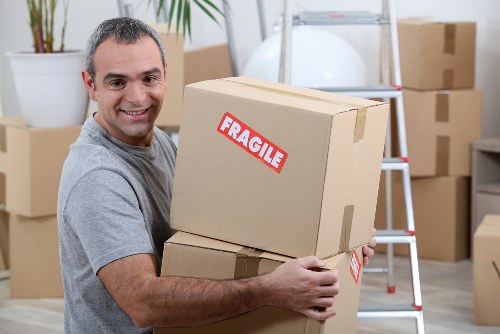 Removal van and moving team preparing boxes safely in Kensington