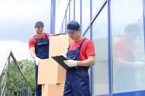Professional man and van team handling furniture transport in Kensington