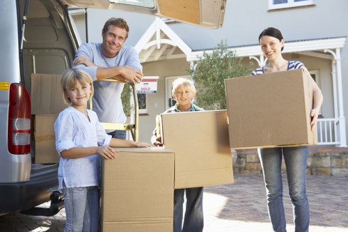 Removal professionals unloading items at a Kensington property entrance