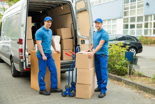 Expert movers organizing and unpacking boxes in a Kensington property