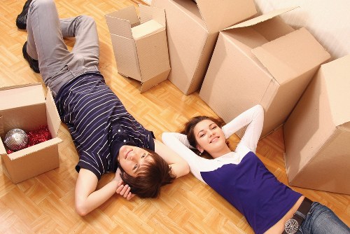 Mover carrying furniture carefully through a property entrance