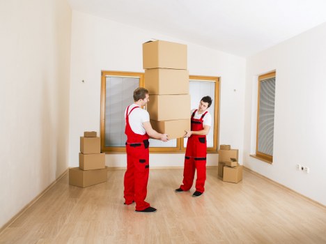 Moving van near Kensington streets with packing boxes and furniture